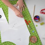 Pattern on a lime green polka dot fabric, with sewing supplies scattered around.